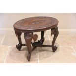 An Anglo-Indian chip carved rosewood 'elephant' table, early 20th century, the oval top centred with