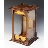 A mid-19th century mahogany cased glass display case, the square moulded top applied with an open