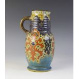 A Gouda pottery ewer, circa 1930, decorated in the Purdah design, hand painted maker's marks to