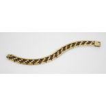 A 9ct gold brick link bracelet, comprising alternating plain polished and textured links, lobster