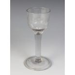 An engraved ogee bowl cordial glass, the bowl naively engraved with floral and foliate sprays,