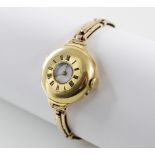 A lady's continental 18ct gold wristwatch, white enamel dial with black Roman numerals, half-