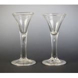 Two conical wine or cordial glasses, each with flared bowl on tear drop stem terminating in wide