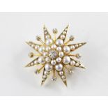 A diamond and cultured pearl star-burst brooch, the central old cut diamond within a surround of