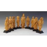 A set of eight Chinese carved figures depicting the Eight Daoist Immortals (Ba xian), each