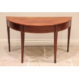 A George III mahogany side table, the D shaped top above a single frieze drawer, raised upon legs of