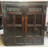 A large carved oak hall cupboard/court cupboard, converted to a wardrobe, 17th century and later