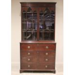 A George III mahogany secretaire bookcase, the moulded cornice above a pair of Gothic style astragal