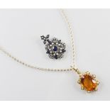 An Edwardian style citrine and pearl set cluster pendant, the central oval faceted citrine measuring