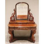 A Victorian mahogany Duchess dressing table, the arched swivel mirror raised upon scrolling open