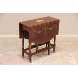 An Edwardian mahogany Sheraton revival Sutherland table, the rectangular table top centred with an