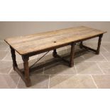 An English country house kitchen table, 18th century, the four plank gnarled oak top with incised