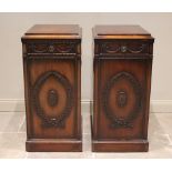 A pair of Victorian Adam revival mahogany pedestals, each with a single drawer over a cupboard