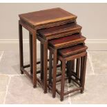 A nest of four Chinese hard wood quartetto tables, each table with a cleated top and raised upon