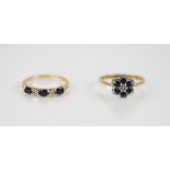 A diamond and sapphire five stone 18ct gold ring, comprising three oval mixed cut sapphires and