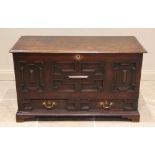 A late 17th/early 18th century oak mule chest, the moulded three plank top above a front panel