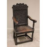 A 17th century and later oak wainscot chair, the panelled back with caryatid carved pediment,