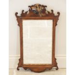 A George III style mahogany fretwork wall mirror, with a gilt phoenix crest above the rectangular