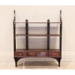 A 19th century mahogany wall shelf, the three reeded shelves over three small drawers, united by