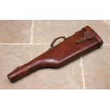 A late 19th/early 20th century leather leg of mutton gun case, applied with loop handles, brass lock