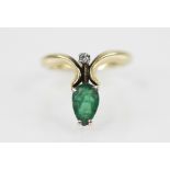 An emerald and diamond 18ct gold ring, comprising a pear-shaped emerald measuring 8mm x 5mm, and a