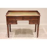 A 19th century mahogany writing desk, the rectangular top with a three quarter gallery enclosing a
