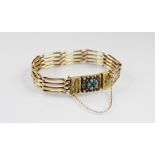 A Victorian bracelet, the rectangular clasp set with a turquoise and ruby floral cluster and and