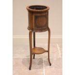 An Edwardian Sheraton revival cylinder jardiniere stand, inlaid with satinwood banding, raised on