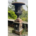 A large and impressive pair of 19th century style cast iron garden urns on plinths, of campana form,