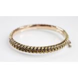 A Victorian 9ct gold hinged bangle, of braided design with beaded decoration, 65mm x 56mm, tongue
