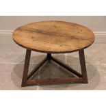 A late 18th / early 19th century oak cricket table, later reduced, the circular four plank top