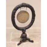 A Victorian carved oak freestanding dinner gong, of wreath form, carved in relief with berries and