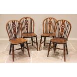 A matched set of four Victorian elm and beech wood wheel back kitchen chairs, each with a hoop
