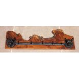 A wall mounted cast iron and yew wood hat/coat rack, the rough cut timber applied with two cast iron