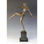 After Pierrele Faguays, an Art Deco patinated bronze figure modelled as a dancing girl with a floral