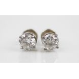 A pair of diamond solitaire earrings, each round brilliant cut diamond weighing approximately 0.85