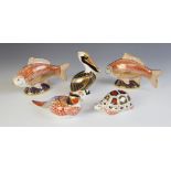 Two Royal Crown Derby Golden Carp paperweights, each with gold stoppers, both boxed, with a P W