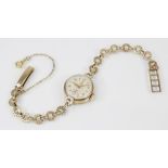 A lady's vintage 9ct gold Tudor wristwatch, the round cream dial with Arabic and baton markers and