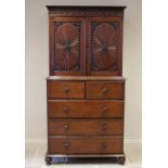 A mid 19th century Anglo Indian teak linen press, the upper frieze carved with leafy swags and