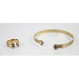 An 18ct gold diamond set torque bangle, the three-colour 18ct gold bangle of reeded form with