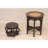 A Chinese hardwood urn stand, early 20th century, the circular top inset with a central rattan panel