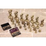 A large collection of brass weights, to include; graduated bell shaped weights, the largest 18cm