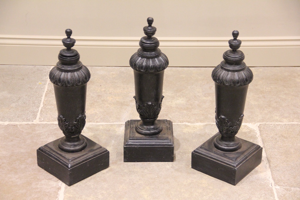 A set of three painted hardwood lamp bases, each of classical vase form with acanthus leaf moulded