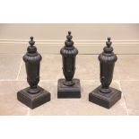 A set of three painted hardwood lamp bases, each of classical vase form with acanthus leaf moulded