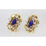 A pair of diamond and lapis lazuli set 18ct gold earrings, each with a central polished lapis lazuli