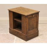 A mid 20th century oak magazine table/cabinet bearing a Gordon Russell label, the rectangular