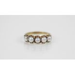A mabe pearl 9ct gold ring, comprising five mabe pearls measuring 3.5mm diameter, all set in 9ct