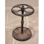 A Victorian cast iron four division umbrella stand, the circular top raised upon a ring turned