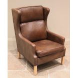A Borge Morgensen Danish style leather armchair, circa 1960, the tan leather chair with shaped