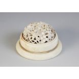 A carved ivory Canton cricket cage, 19th century, of circular form and the cover decorated with a
